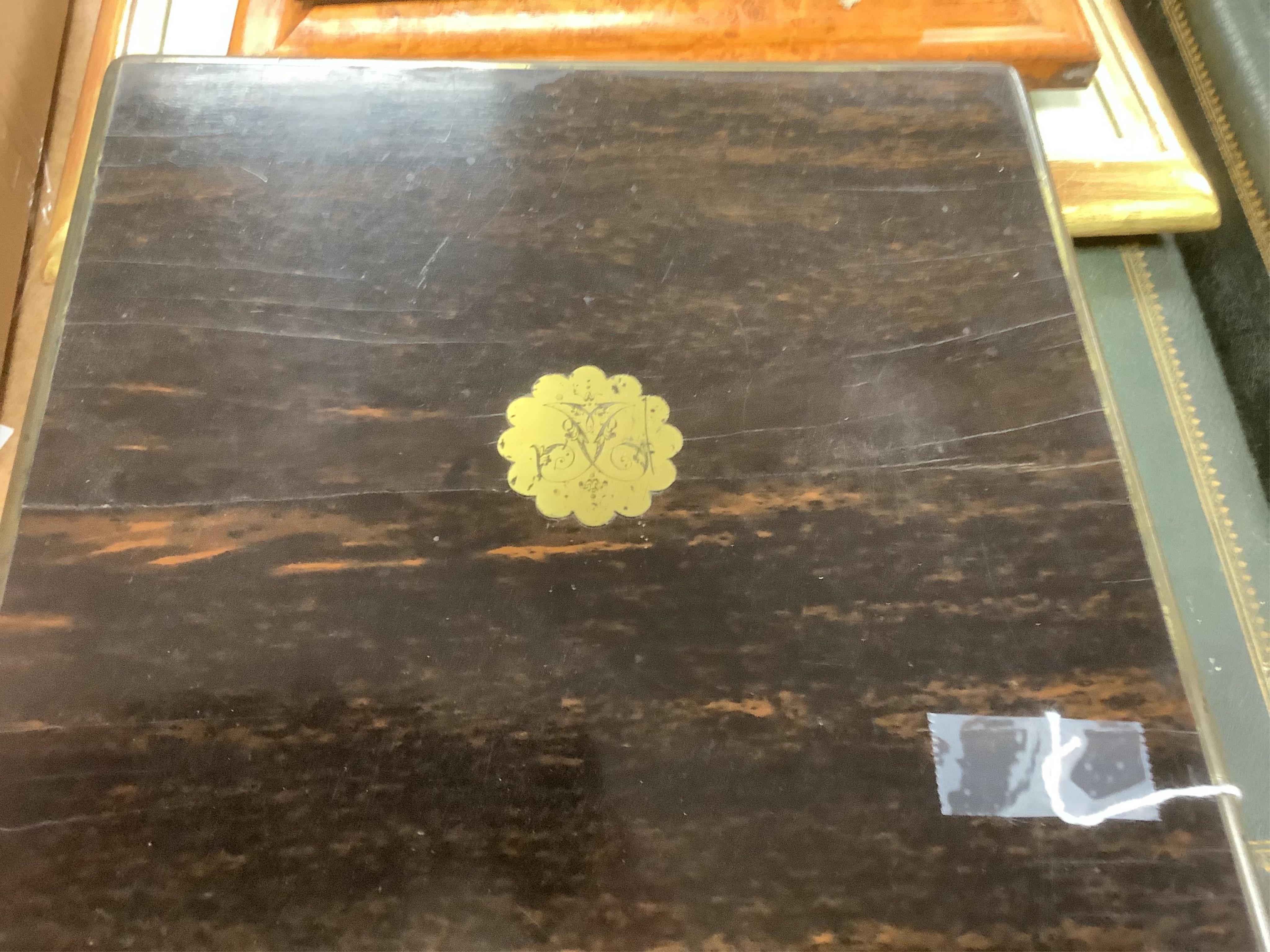 A Victorian brass mounted coromandel wood travelling toilet box, containing nine engine turned silver mounted cut glass toilet jars, with engraved initial, Brownett & Rose, London, 1870, the box of square form, with inse